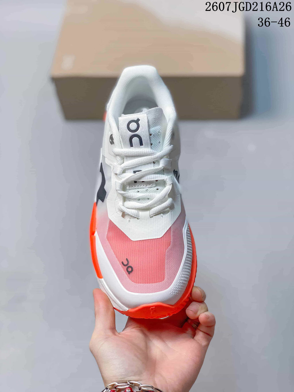 Top view showing the white laces, padded collar, tongue branding and pink mesh toe panel.