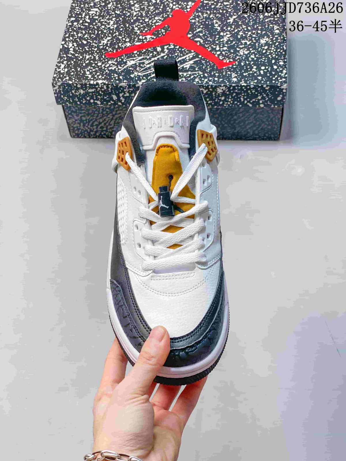 Top view showing white laces, gold tongue detail, and navy textured toe overlays.
