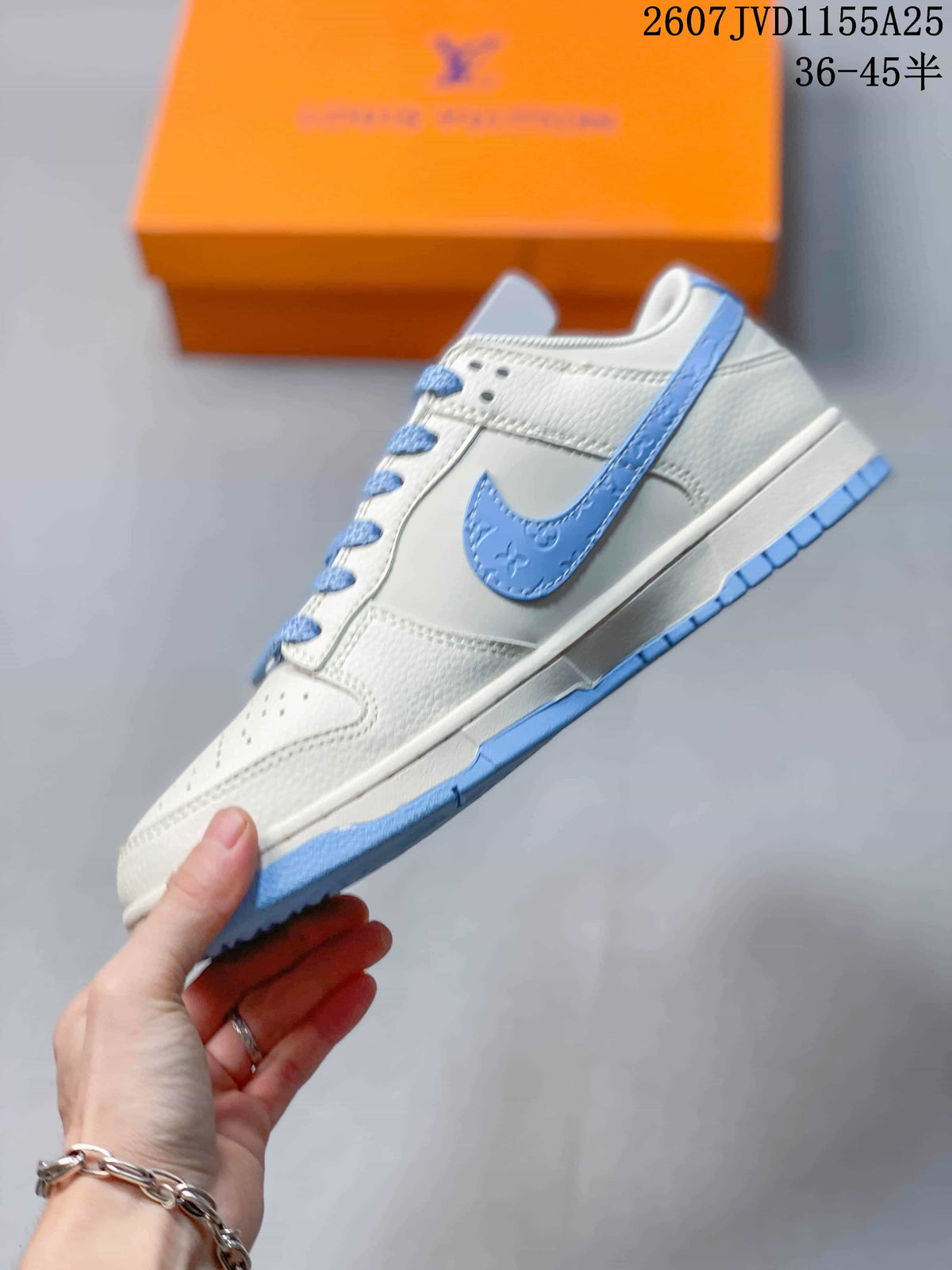 Side view showing the white low-top upper, light blue Swoosh-style accent, and blue outsole.