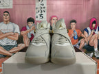 Front view showing the tongue branding and cross-strap details on the sneakers