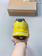 Rear view of the yellow ASICS sneaker with a charcoal heel collar.