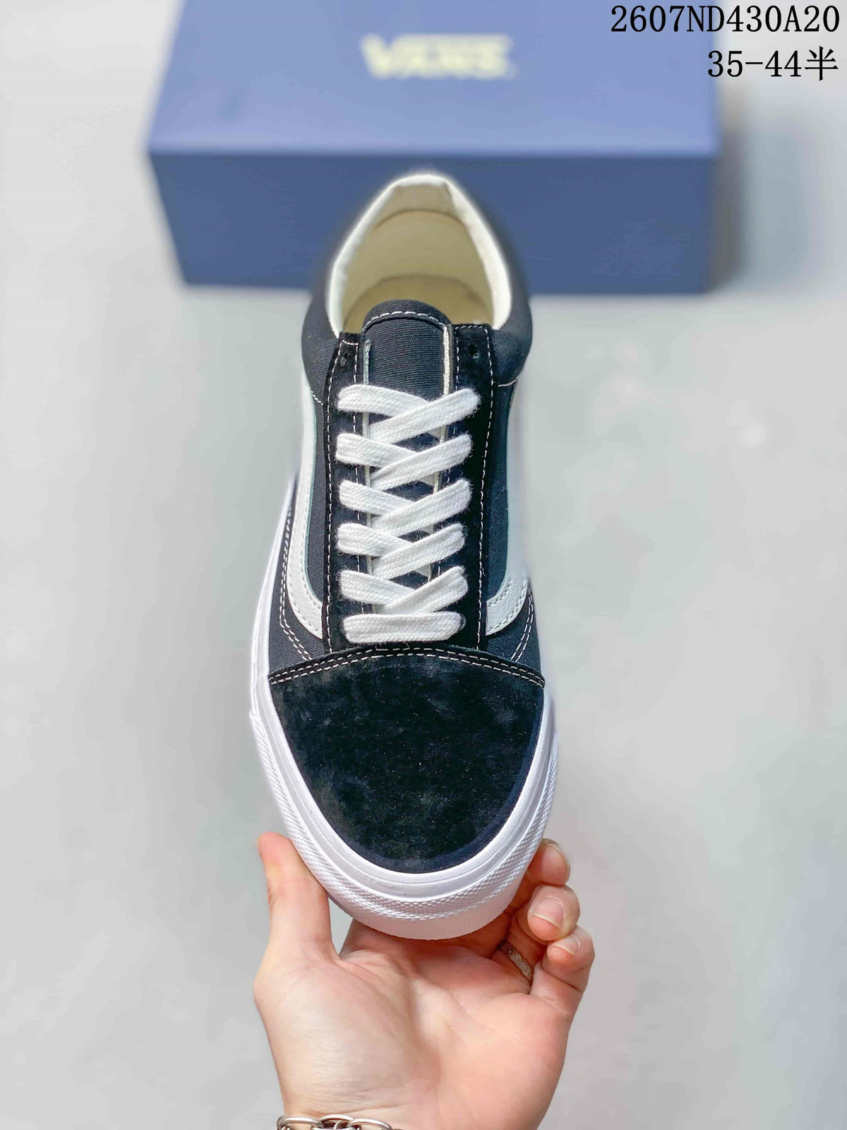 Top view showing the black toe area, white laces, tongue, and contrasting side details.