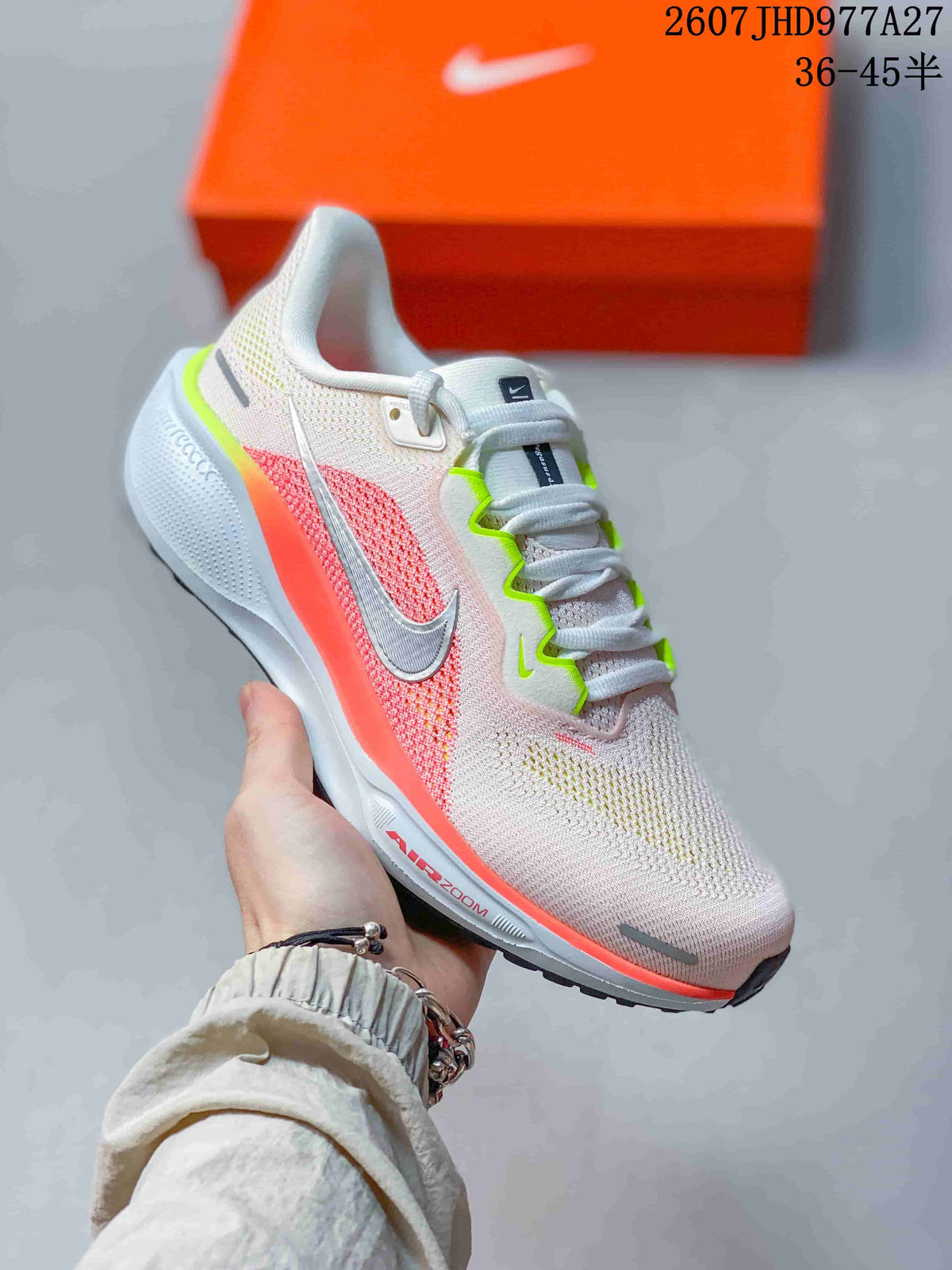 Angled side view of the light pink and white Nike Quest 6 shoe with coral and neon green details.
