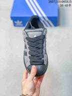 Top view showing the black laces, grey panels and shell toe.