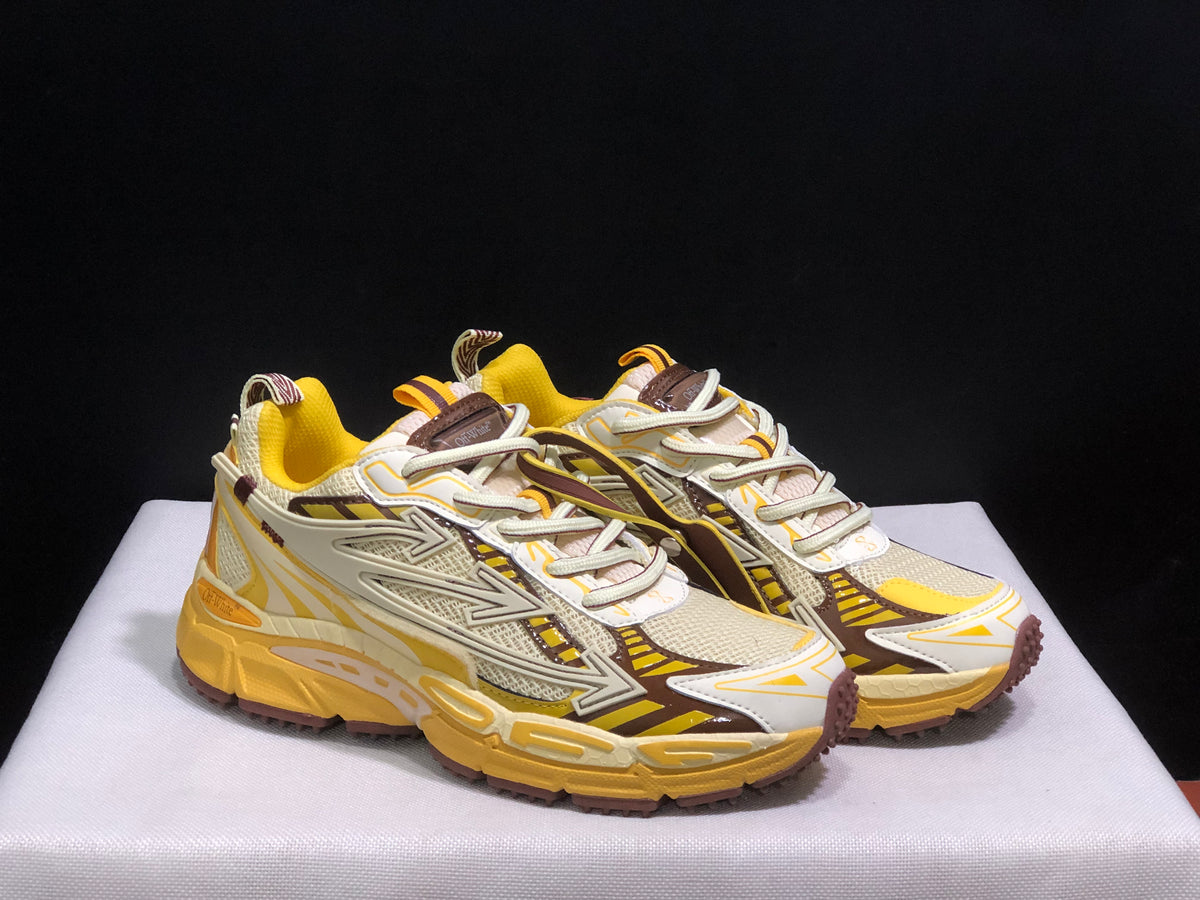 Front three-quarter view of both sneakers highlighting the cream toe panels, brown accents, and yellow midsoles.