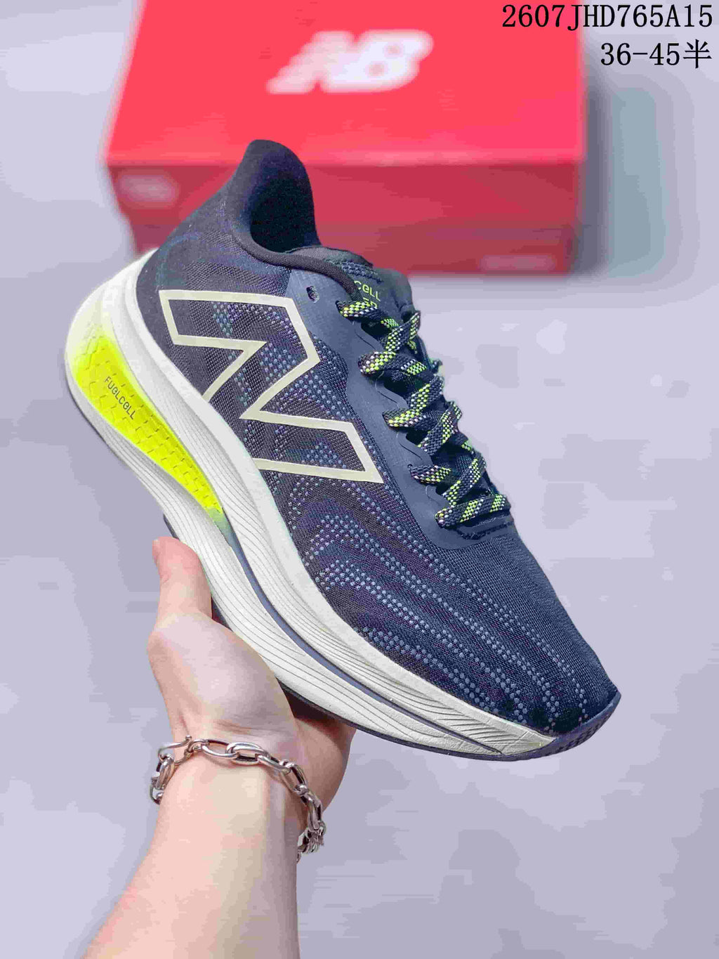 Angled side view of the New Balance RC Elite running shoe showing the logo, layered light midsole and neon yellow heel insert.