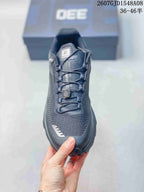 Top view of a dark gray Kailas trail shoe showing the tongue branding, laces, and central lace adjustment component.