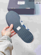 Close view of the textured rubber outsole on a blue and white sneaker; the source overlay shows EU size range 36–45.