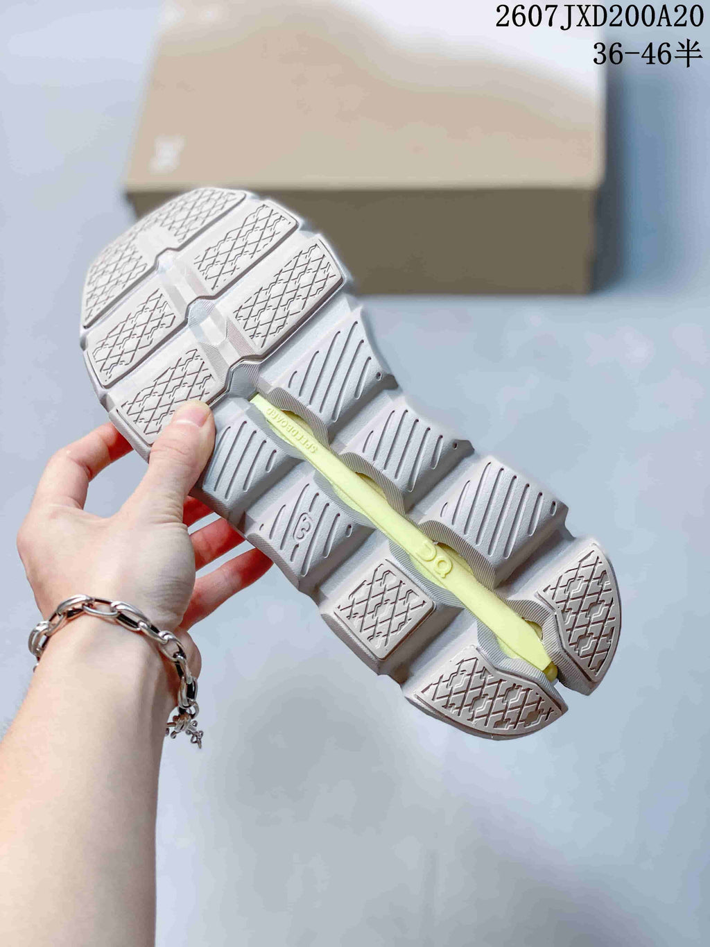 Close view of the segmented outsole with textured traction panels and open channels.