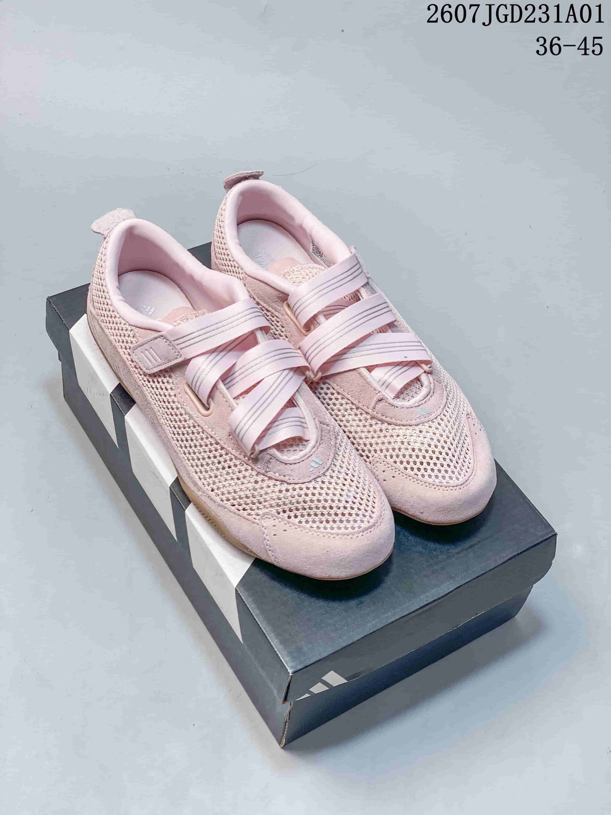 Pair of pink Adidas Urban Reverie sneakers with crossed straps and a gum-colored outsole