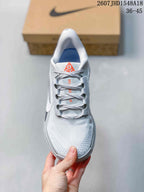 Top view of the sneaker showing the textured toe area, gray laces, padded tongue, and orange tongue label.