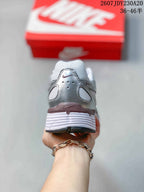Rear view showing the padded heel, layered panels, and white midsole.