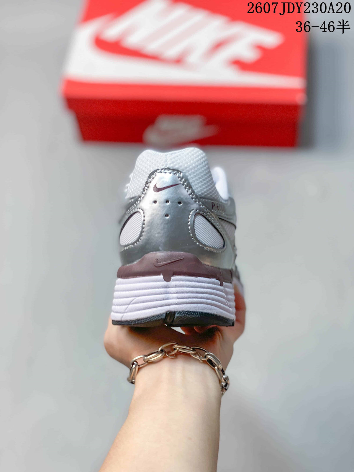 Rear view showing the padded heel, layered panels, and white midsole.