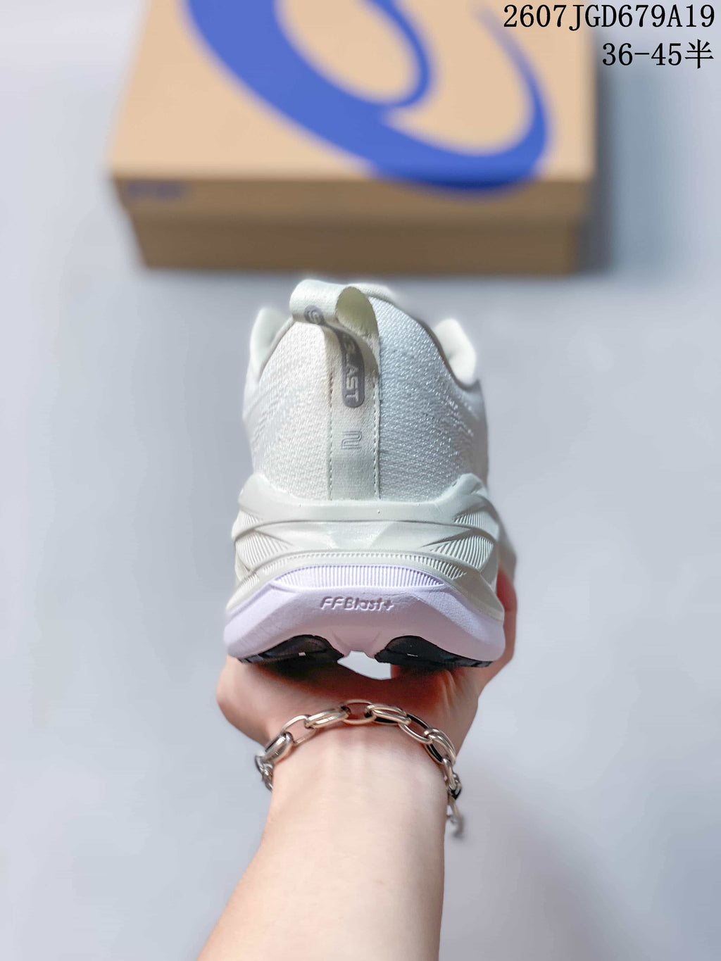 Rear view of a white ASICS Superblast 2 sneaker showing the padded heel, pull tab, sculpted heel structure, and outsole.