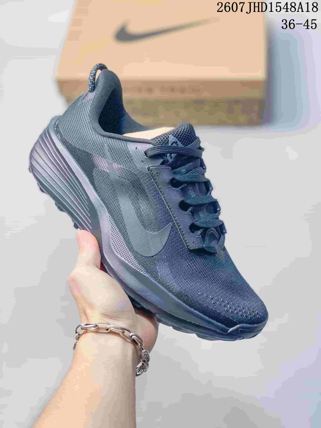 Dark gray Nike ReactX Pegasus ACG Trail 6 sneaker with tonal branding and a textured sole.