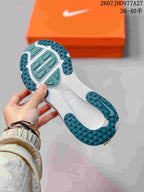 Underside view of a sneaker showing the white and teal segmented outsole with textured traction areas; overlay text shows style code 2607JHD977A27 and sizes 36–40.5.