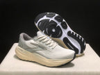 Angled view of the sneakers with one shoe lifted to show the black-and-white outsole pattern.