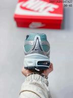 Rear view showing the teal mesh heel, silver overlay, and visible outsole section.