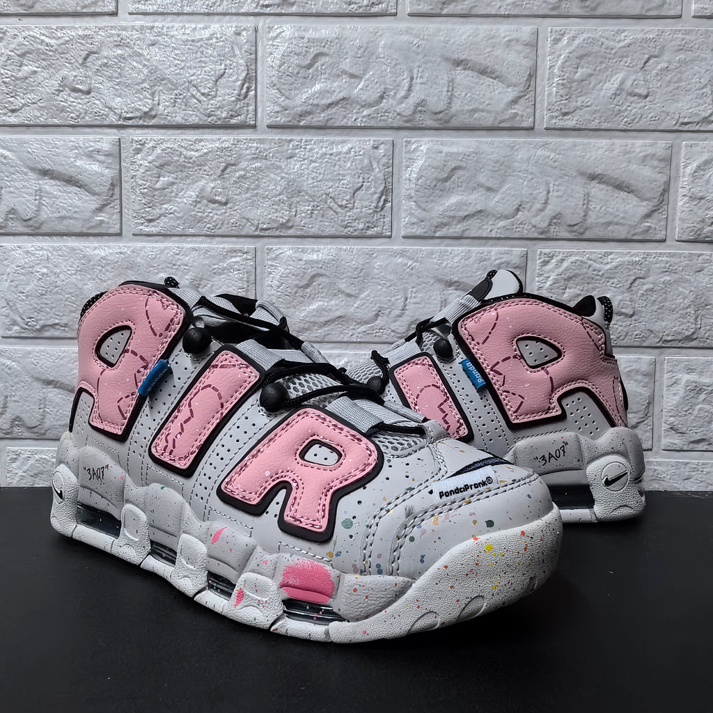 Pair of pink and grey Nike sneakers shown from a front three-quarter angle