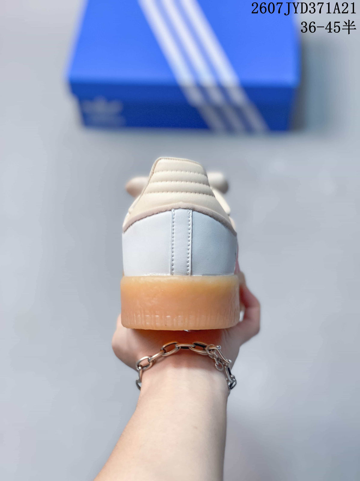 Rear view of the sneaker showing the white heel, padded collar, and gum-colored sole.