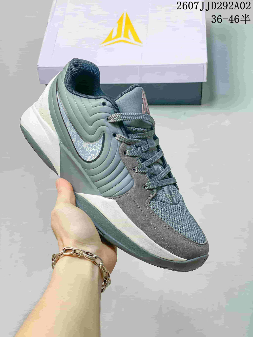 Grey and sage Nike JA 2 basketball shoe with a reflective-looking Swoosh detail.