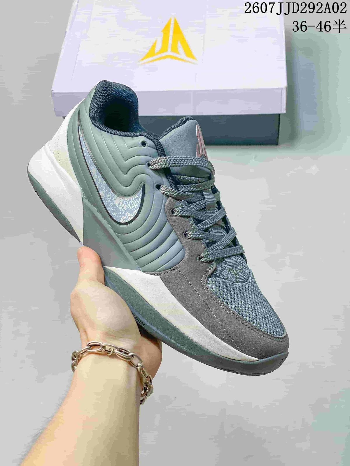 Grey and sage Nike JA 2 basketball shoe with a reflective-looking Swoosh detail.