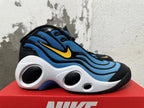Side profile of a blue, black, and white Nike sneaker with yellow Swoosh and podded midsole.
