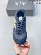 Front view showing the rounded toe, lace-up closure, textured upper, and contrasting side logo.