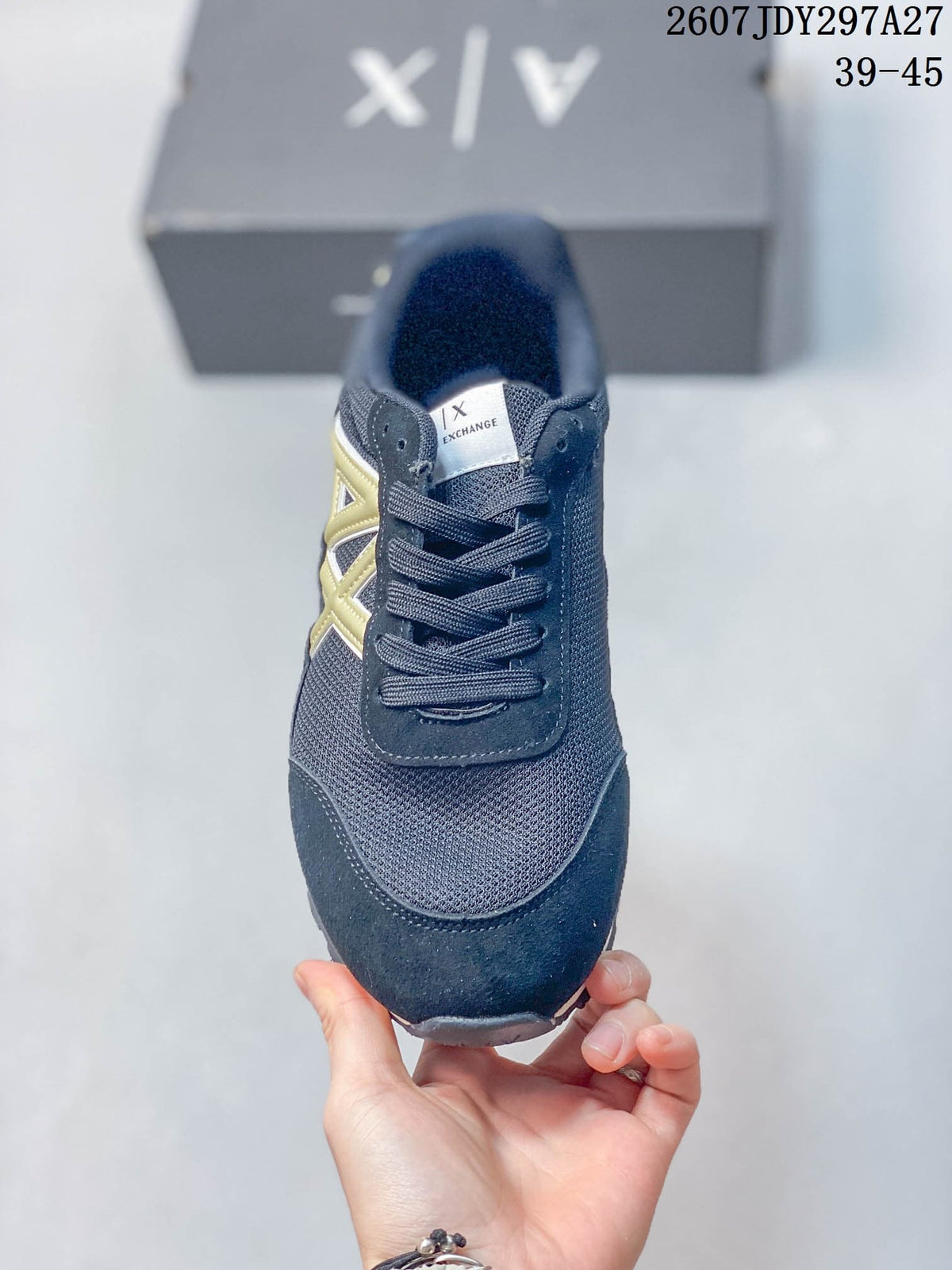 Front view showing the rounded toe, lace-up closure, textured upper, and contrasting side logo.