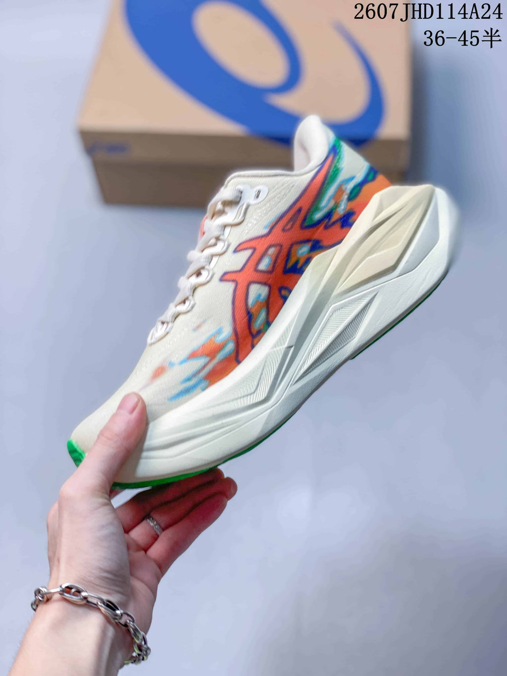 Side profile of the cream running sneaker showing the multicolor ASICS side design, sculpted midsole and green outsole edge; image text shows 2607JHD114A24 and 36–45 half sizes.
