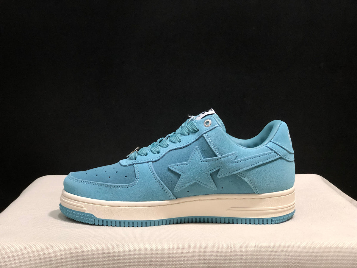 Side profile of one light blue BAPE STA sneaker showing the layered upper, star detail, padded collar, and blue outsole.