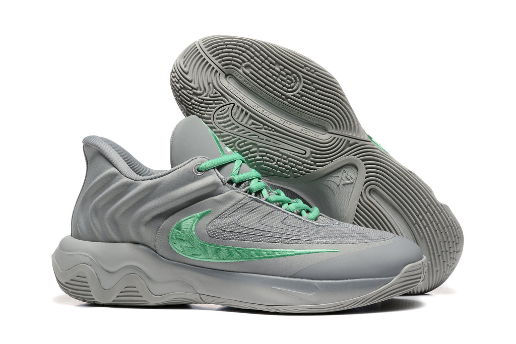 Gray sneakers shown with detailed patterned outsoles