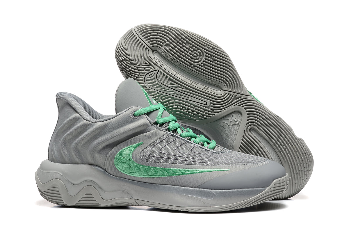 Gray sneakers shown with detailed patterned outsoles