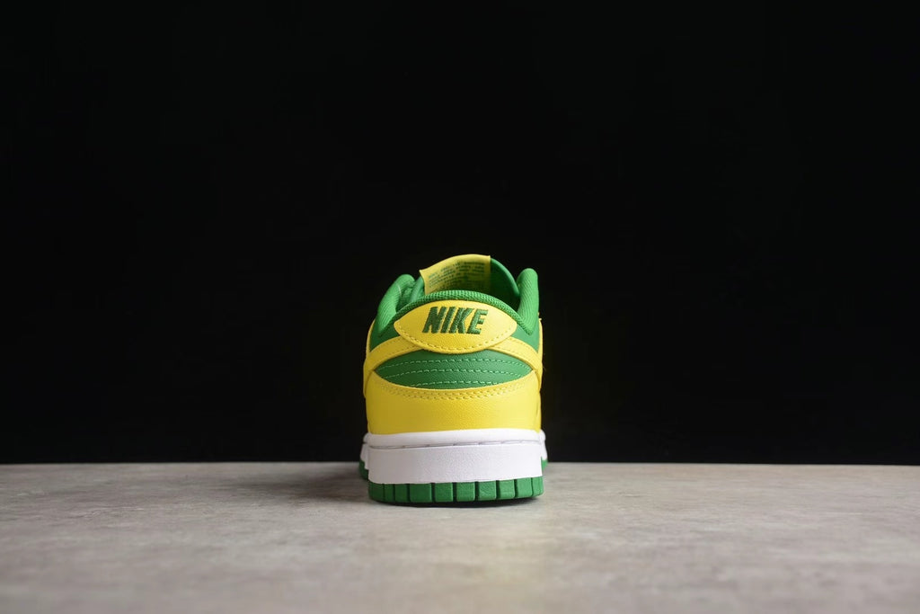 Rear view showing the green and yellow heel construction, white midsole, and green outsole.