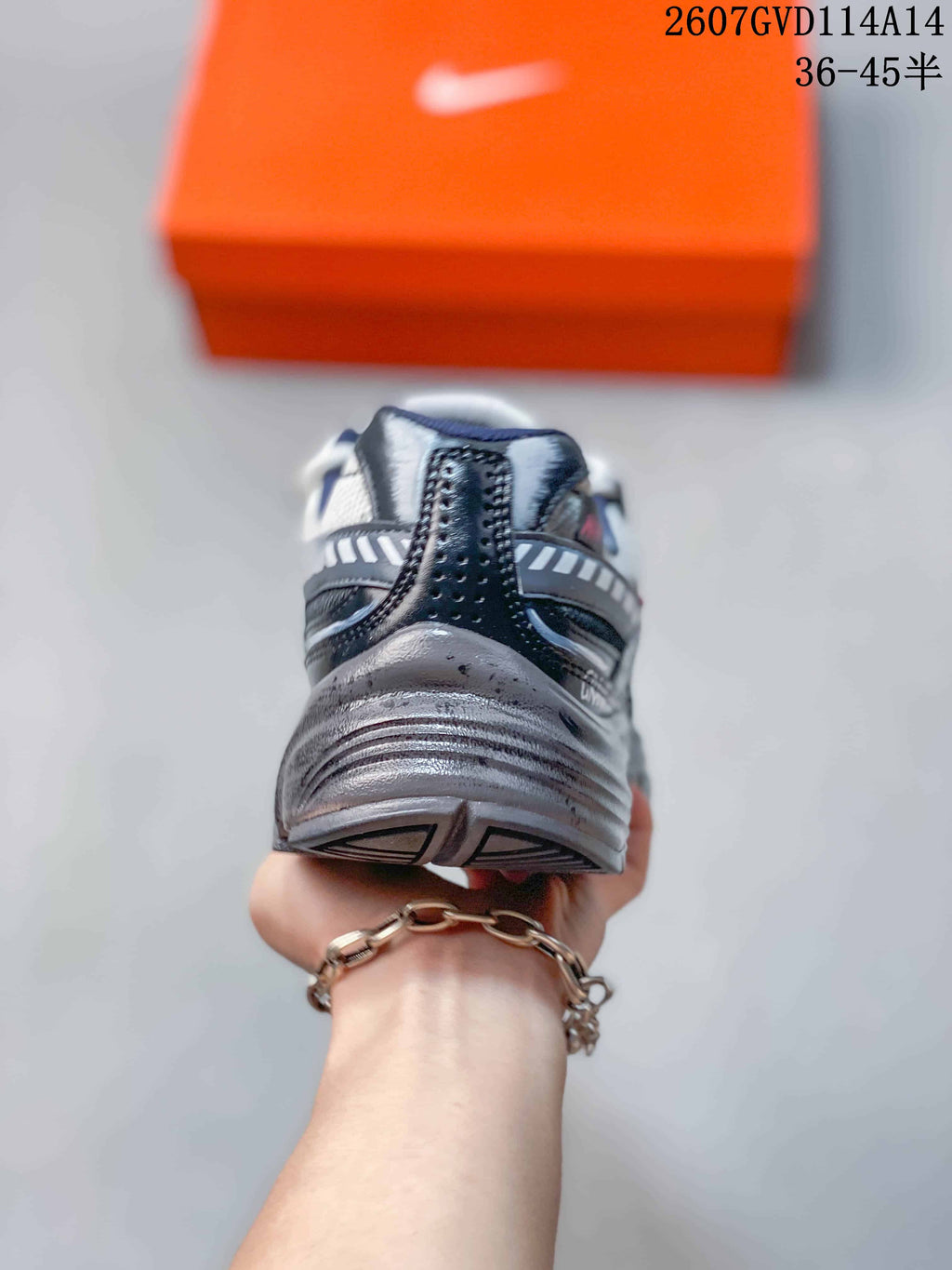 Rear view showing the padded collar, layered heel construction, and textured outsole.