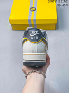 Rear view showing the heel branding, white upper, and gray outsole.