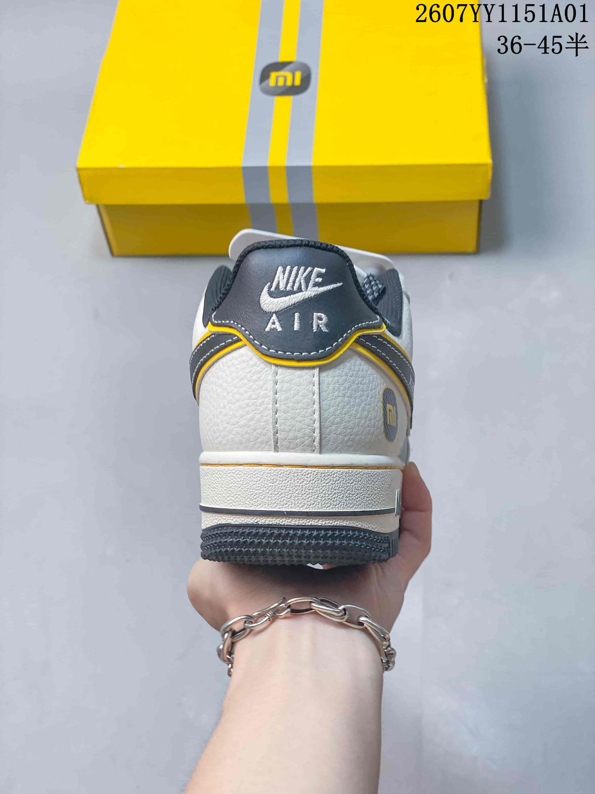 Rear view showing the heel branding, white upper, and gray outsole.