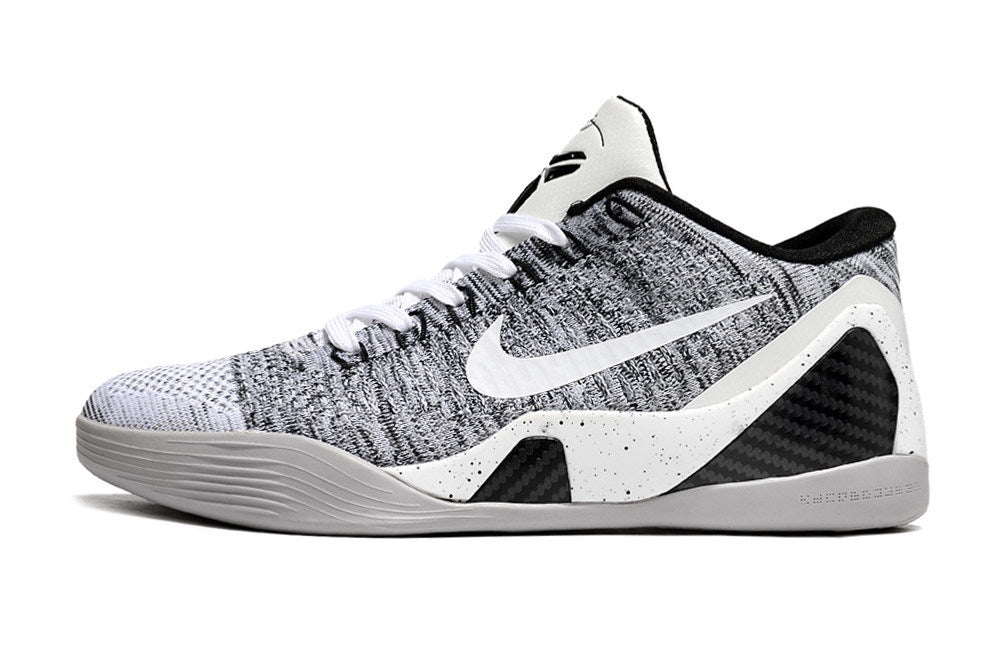 Side view of a white and black low-top basketball shoe.