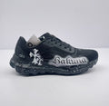 Side view of black alo sneakers with white Sakura graffiti artwork and a speckled sole.