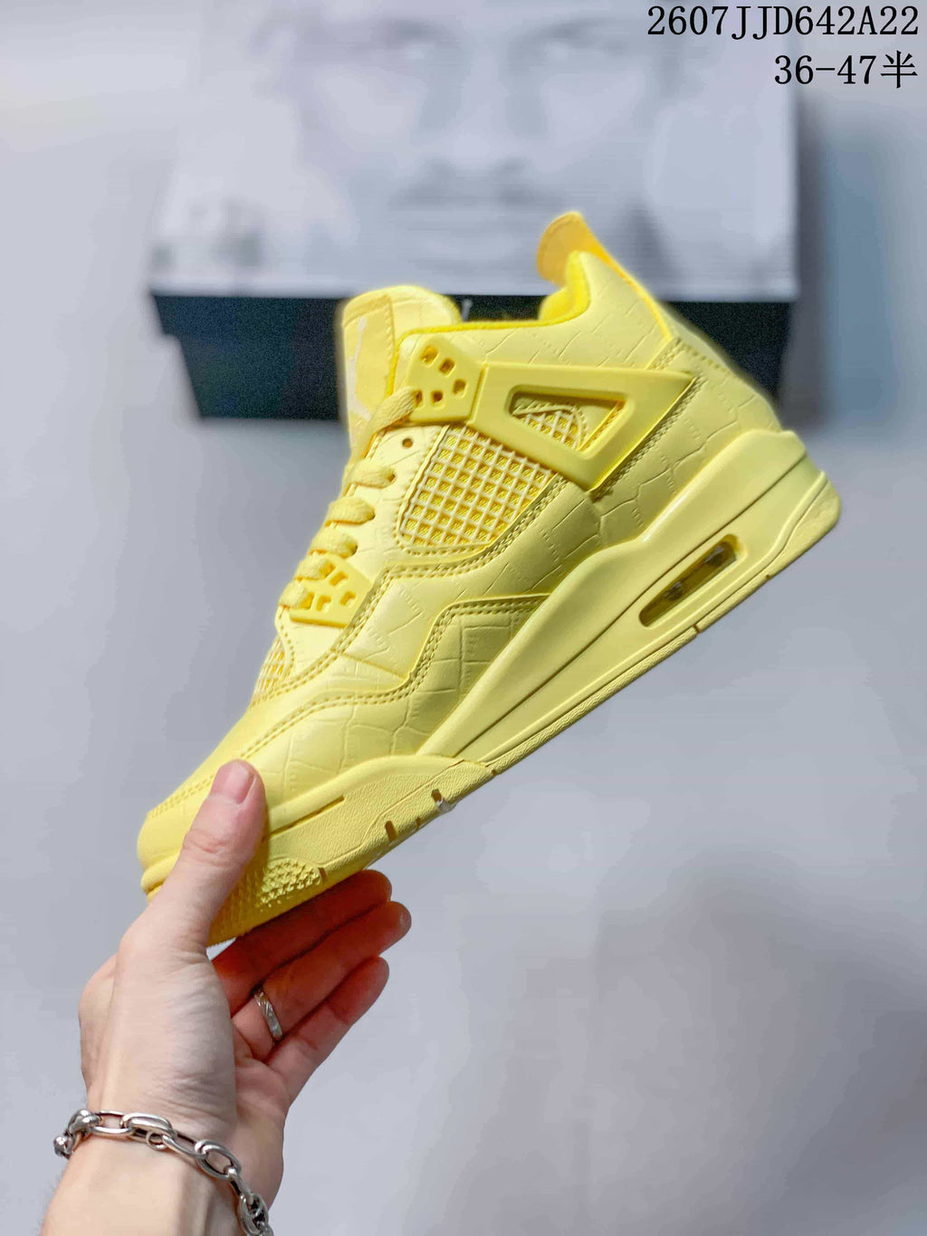 Side profile of the yellow high-top sneaker showing the mesh panel, structural side cage and visible midsole air window.