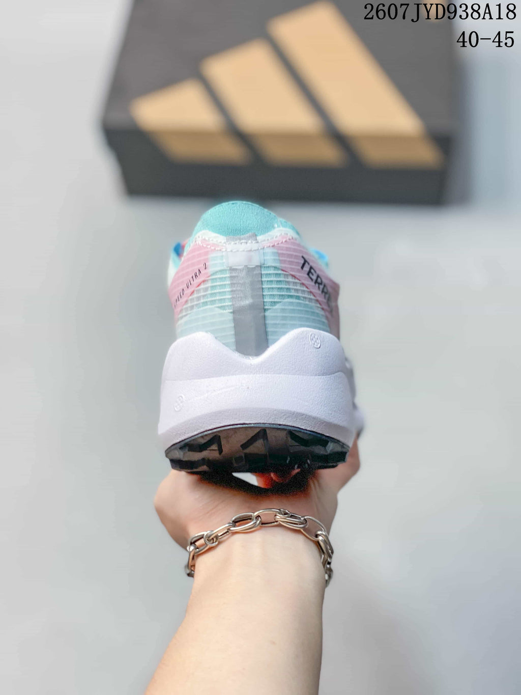 Rear view of the shoe showing the blue collar lining, translucent upper panels, white midsole, and black outsole; size range text 40–45 is visible.