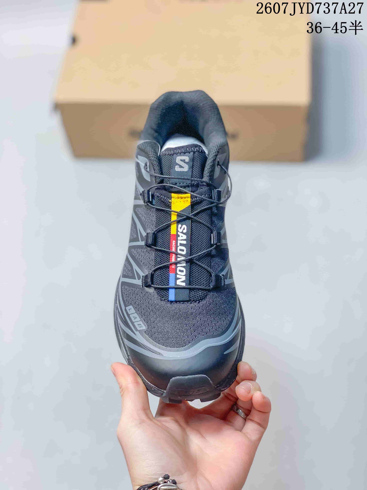 Front view of the Salomon sneaker showing the branded tongue panel, lace-lock fastening, and protective toe area.