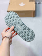 Close-up of the sneaker outsole showing a geometric tread pattern and raised traction sections.