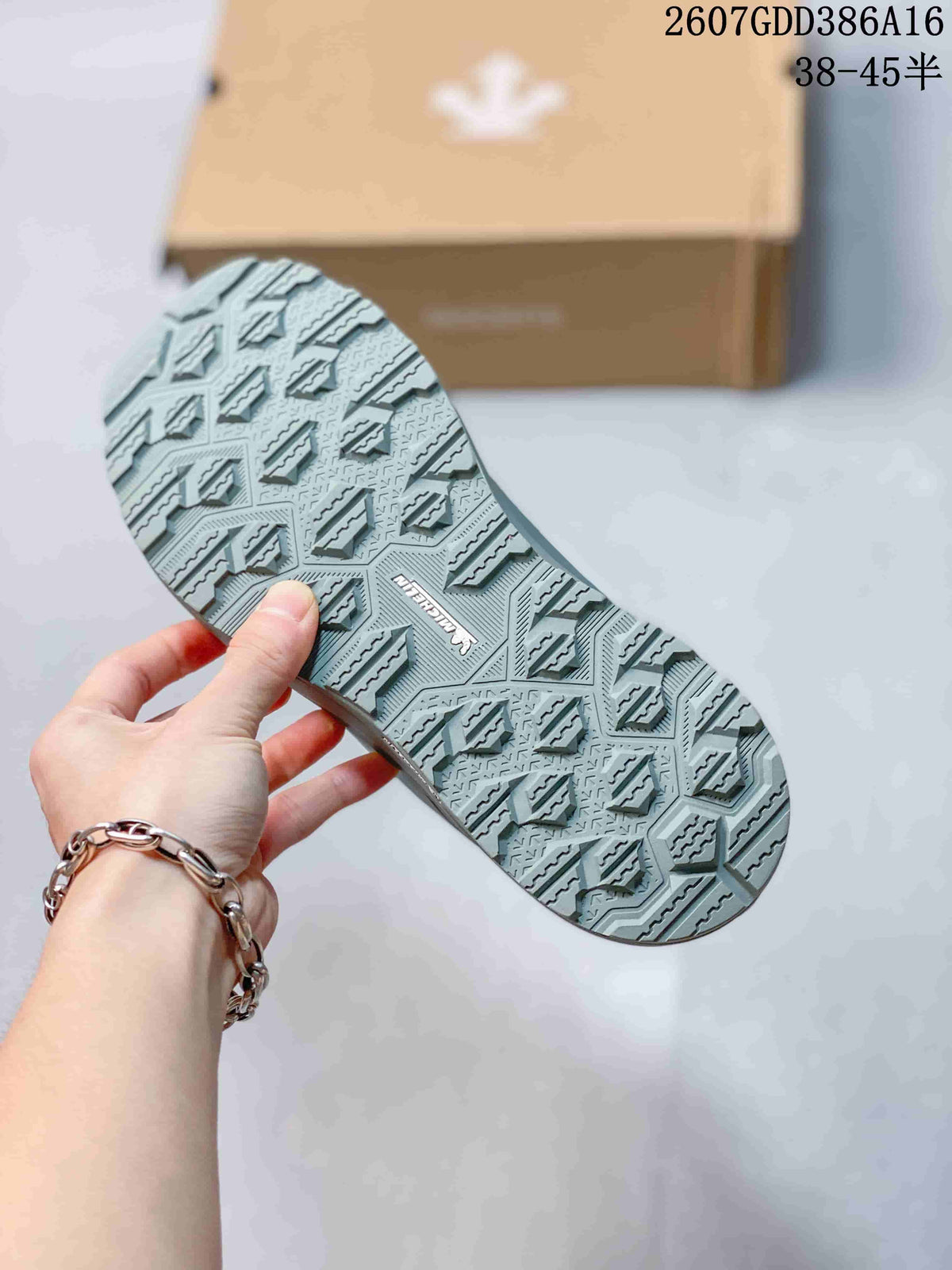 Close-up of the sneaker outsole showing a geometric tread pattern and raised traction sections.