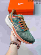 Angled side view of the green and orange Nike Air Zoom Pegasus 39 shoe showing the upper, Swoosh, and midsole.
