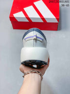 Rear view of the gray sneaker showing its heel pull tab and thick white midsole