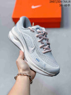 White Nike Journey Run sneaker with pale pink laces and a light blue patterned upper.