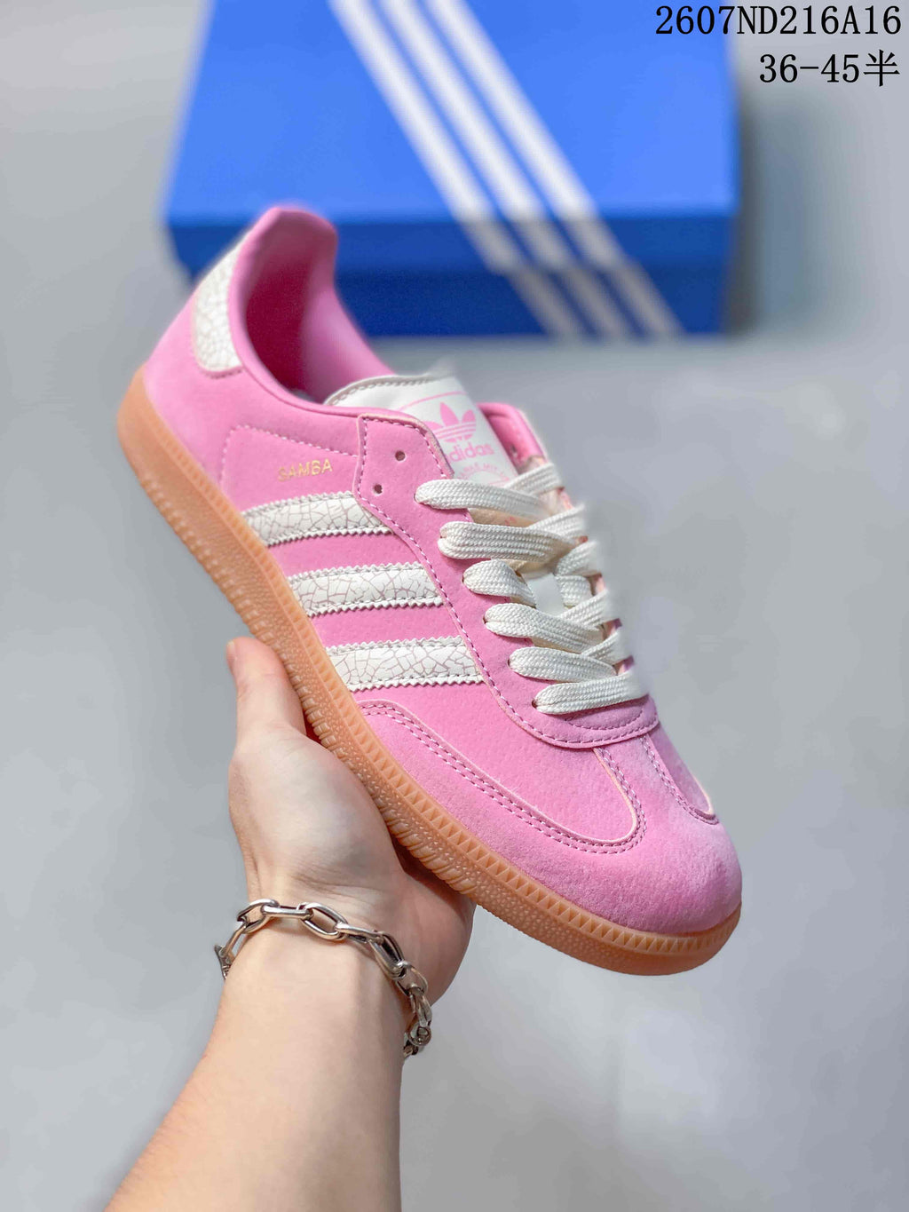 Angled close-up of the pink adidas Samba sneaker showing the side stripes, Samba marking and gum sole.