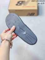 Close view of the textured gray outsole with New Balance branding and circular tread details.