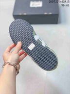 Underside of an Onitsuka Tiger Serrano sneaker showing the dark textured outsole and branding detail; style code and EU size range appear in the background.
